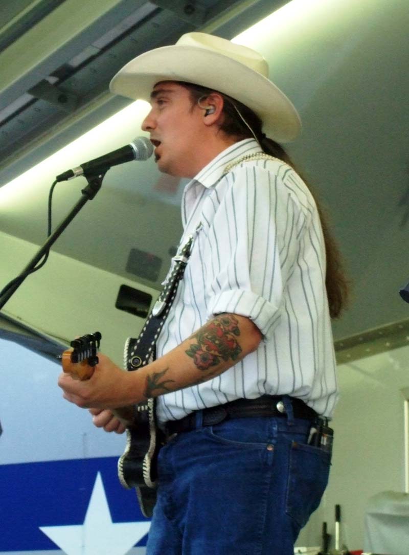 photo of man playing guitar and singing